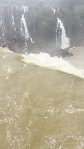 Iguazu Falls brown rapids at the edge of the cascades