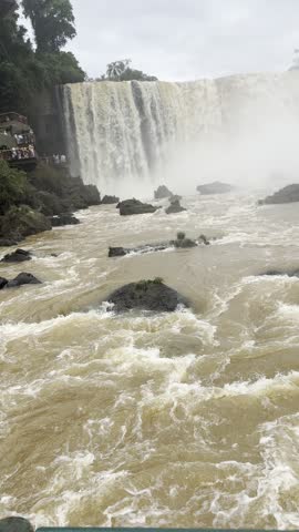Powerful rapids and a cascade with mist at Iguazu Falls