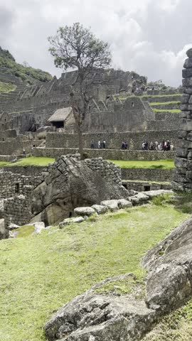 Machu Picchu terraces and ruins with tiny distant visitors, Peru