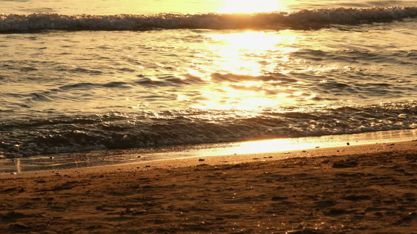Tranquil sunset over the sea from a sandy beach