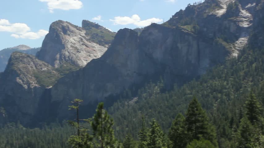 Pan across Yosemite Valley toward El Capitan granite cliffs. California, USA.