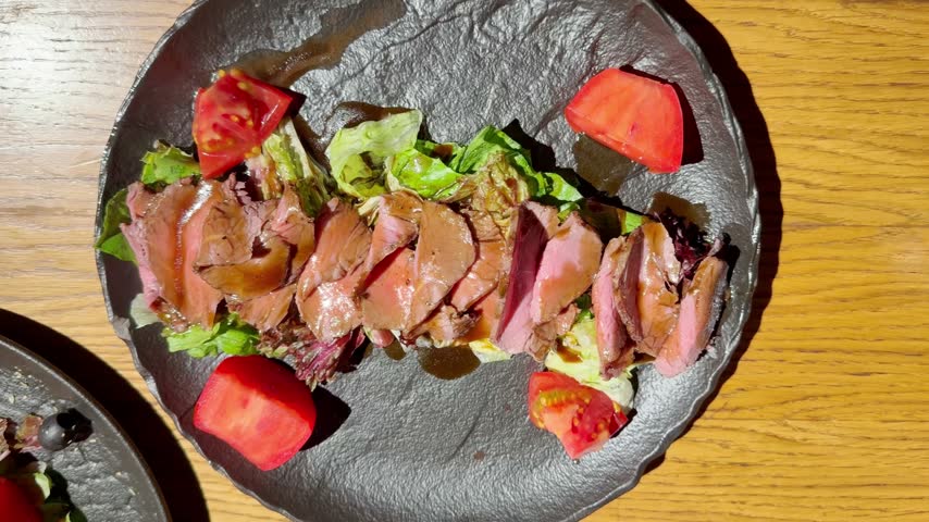 Beef Salad on Plate on Restaurant Table – Fresh Vegetable and Meat Salad Served for Lunch or Dinner