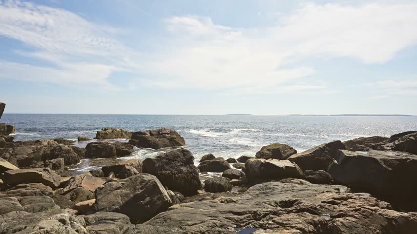 Fractured pink granite ledges stretching toward the Atlantic Ocean at Otter Point in Acadia National Park on Mount Desert Island, Maine.