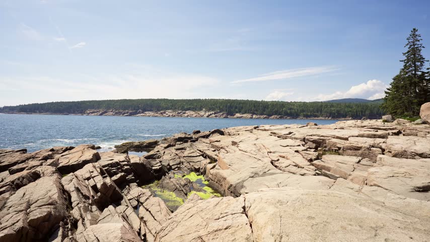 Fractured pink granite ledges stretching toward the Atlantic Ocean at Otter Point in Acadia National Park on Mount Desert Island, Maine.