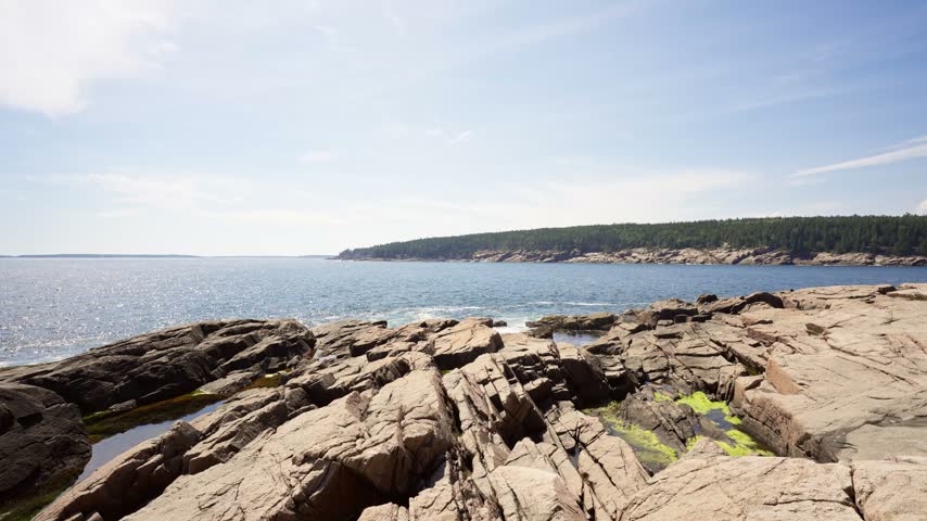 Fractured pink granite ledges stretching toward the Atlantic Ocean at Otter Point in Acadia National Park on Mount Desert Island, Maine.