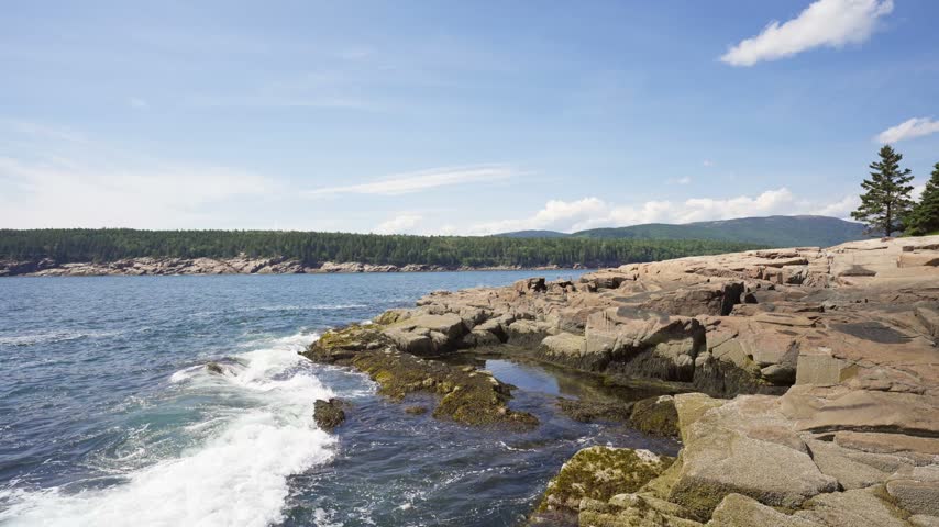 Fractured pink granite ledges stretching toward the Atlantic Ocean at Otter Point in Acadia National Park on Mount Desert Island, Maine.
