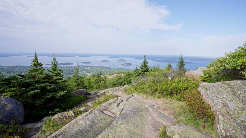 Acadia National Park, Maine landscape video from Cadillac Mountain overlooking Frenchman Bay, offshore islands, and evergreen forests on Mount Desert Island.