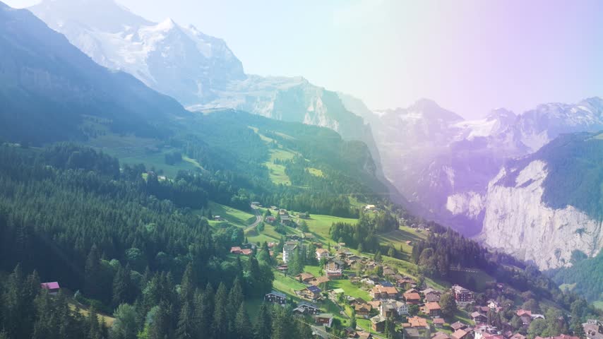Stunning aerial footage of the village of wengen in a green valley in the swiss alps. Switzerland