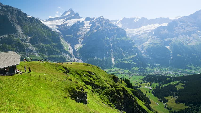 Breathtaking mountain landscape in switzerland with lush green meadows and snow-capped peaks. Switzerland