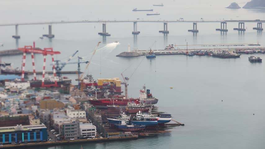Busan Port and harbor of Busan, South Korea, container terminal with gantry cranes, cargo ships at anchor, shipyard docks, fishing boats and ferry terminal between Jung-gu, Nam-gu and Yeongdo island