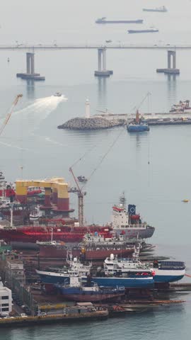 Busan Port and harbor of Busan, South Korea, container terminal with gantry cranes, cargo ships at anchor, shipyard docks, fishing boats and ferry terminal between Jung-gu, Nam-gu and Yeongdo island