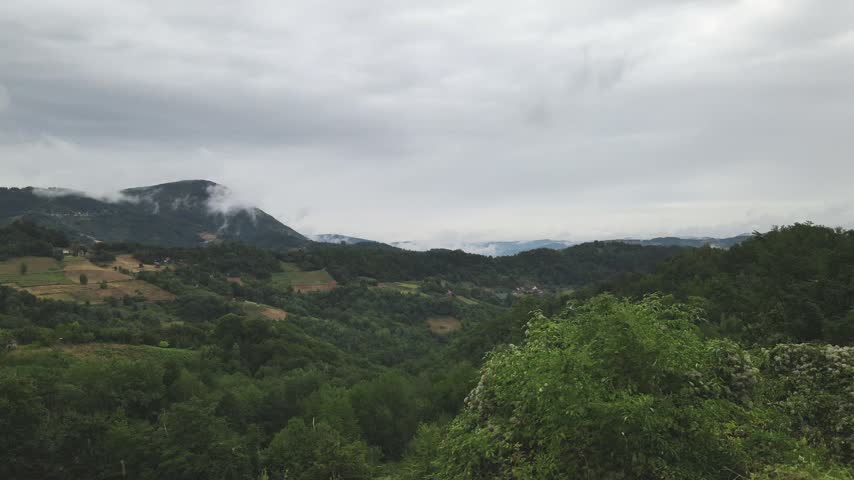 Drone aerial moving forward from western Serbian mountains on a cloudy day