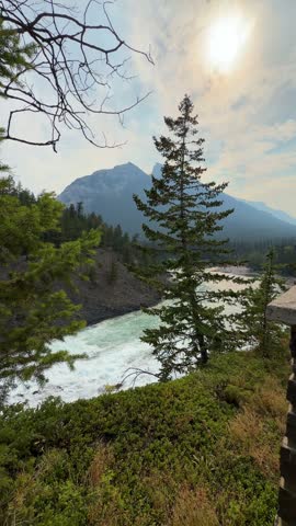 The powerful Bow Falls cascades over wide rock ledges on the Bow River at Banff National Park, Alberta, a scenic whitewater waterfall in the Canadian Rockies.