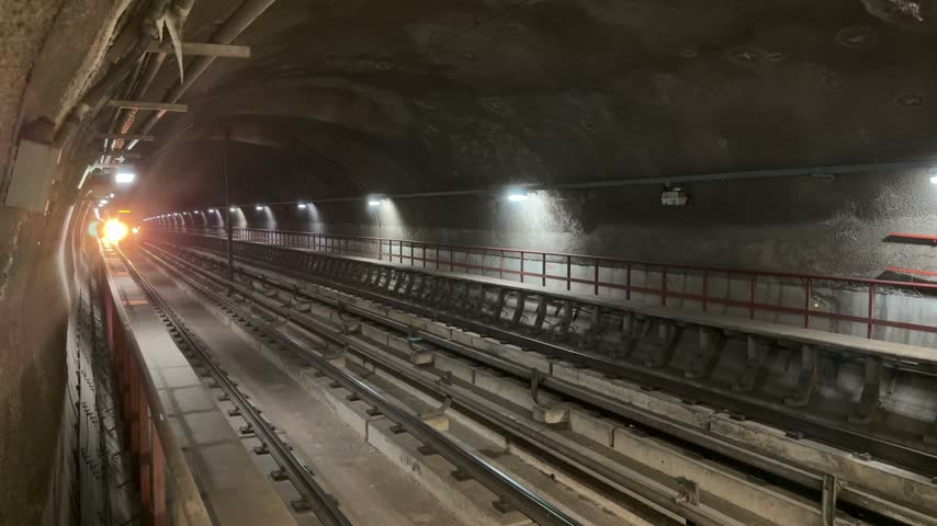 Metro train moves through an underground station in Brasilia with city passengers inside, showing public transportation, urban mobility and modern travel infrastructure