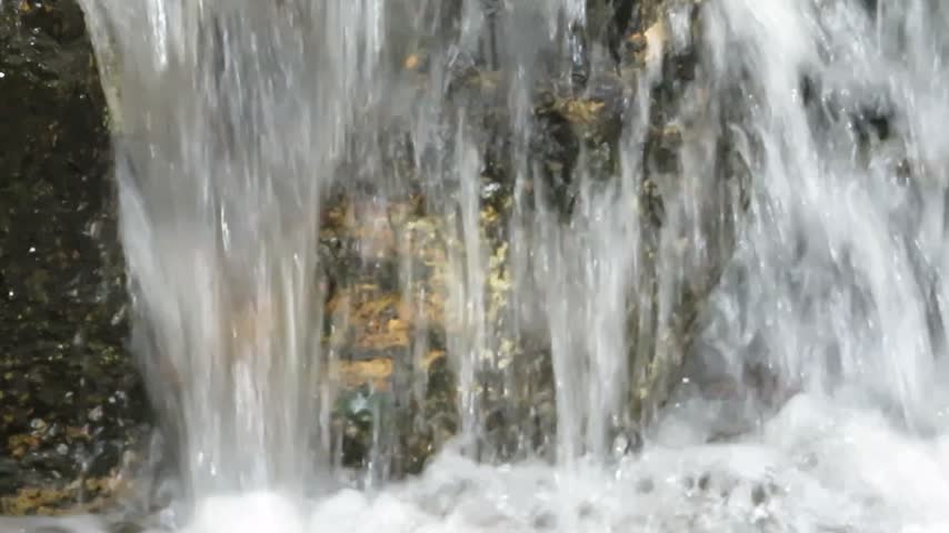 Close Up of Water Falling Over a Rock Face