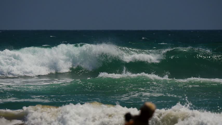 waves breaking down the beach in california
