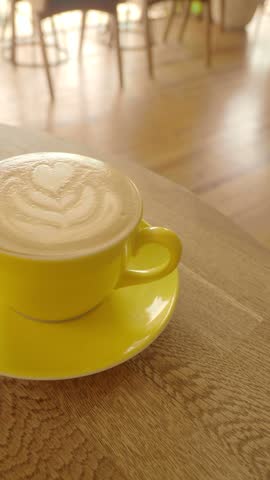 Warm cup of coffee placed on a wooden table