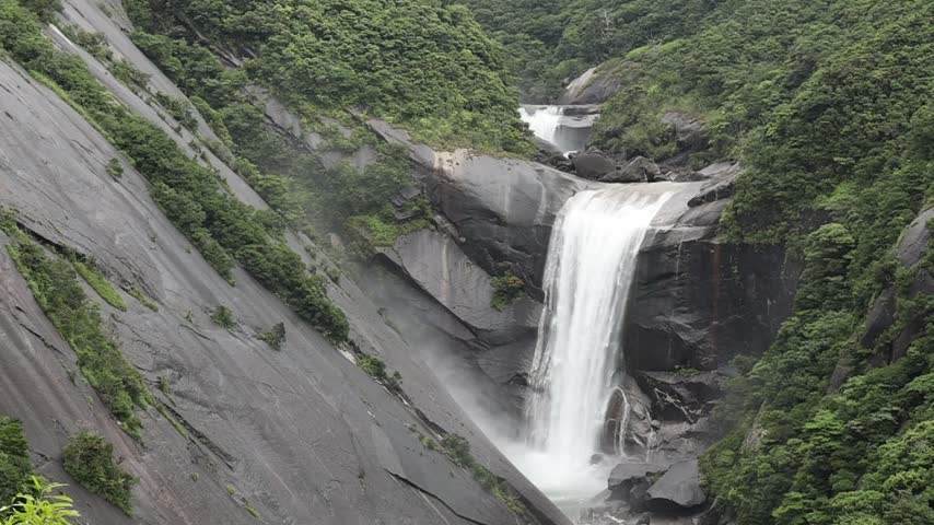the roaring Senpiro waterfall, with its steep granite slopes and lush vegetation