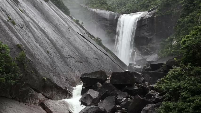the roaring Senpiro waterfall, with its steep granite slopes and lush vegetation