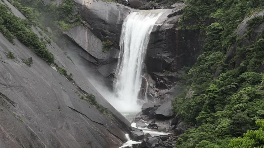 the roaring Senpiro waterfall, with its steep granite slopes and lush vegetation