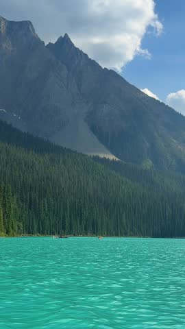 Brilliant turquoise Emerald Lake stretches below forested slopes and Mount Burgess at Yoho National Park, British Columbia, a breathtaking Canadian Rockies landscape.