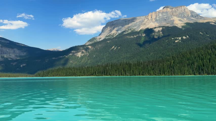 Brilliant turquoise Emerald Lake stretches below forested slopes and Mount Burgess at Yoho National Park, British Columbia, a breathtaking Canadian Rockies landscape.