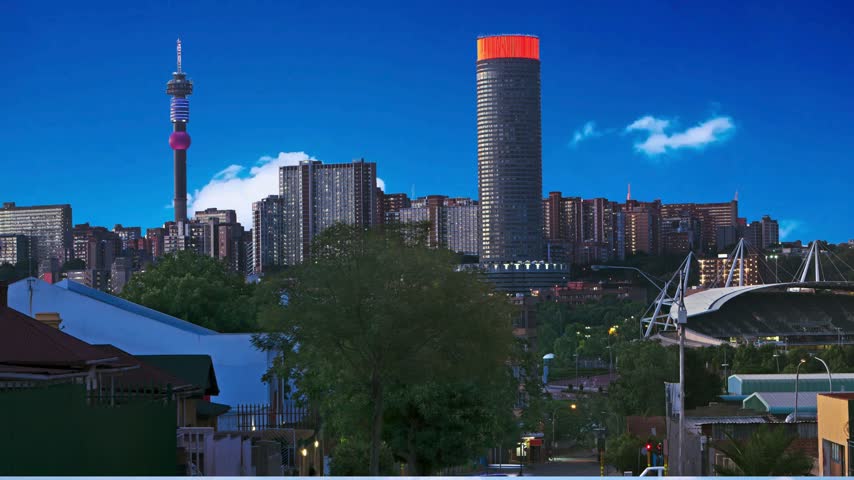 Johannesburg, South Africa  Ponte City Building at sunset. Ponte City is a famous skyscraper in the Hillbrow neighbourhood of  Cityscape of  and PonteBuilding at sunset.  in  ,South Africa: Ponte s a famous skyscraper in the Hillbrow neighbourhood 
african metropolis, apartment buildingarchitectural history,  landmark, built environment, circular facade, buildings,panorama, skyline, cityscape, concrete facade, concrete structure, contemporary architecture, cylindrical tower, distinctive silhouette, dramatic lighting, elevated viewpoint, evening sky, exterior architecture, geometric architecture, golden hour, high-rise construction, hollow core landmark exterior, may 24, metropolitan view, modernist design, ponte city, residential complex, residential high-rise, skyline photography, skyscraper, south africa, south african landmark, sunset, sunset photography, tower block, towering structure, travel photography, urban architecture, urban density, urban development, urban scenery, vertical living, warm sunlight, 