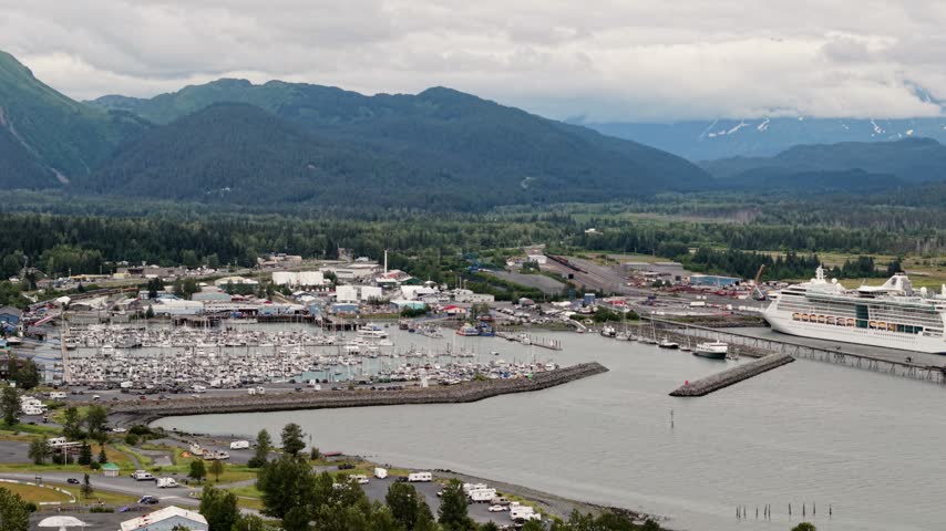 Aerial view of a cruise ship docked at the harbor with mountains in the background in Seward, Alaska, USA. July 18, 2025. 