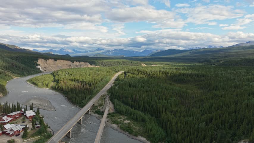 Aerial view of the entrance road and bridge to Denali National Park with mountains in Alaska, USA. July 14, 2025. 