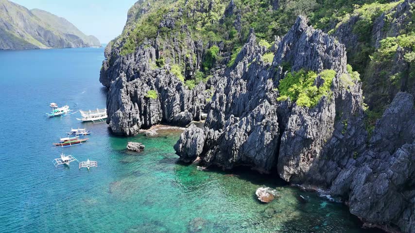 Aerial View of Limestone Cliffs and Outrigger Boats in El Nido, Philippines
