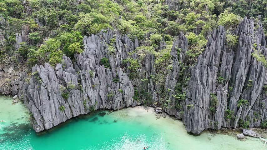Aerial View of Limestone Cliffs and a Sandy Cove in El Nido, Philippines