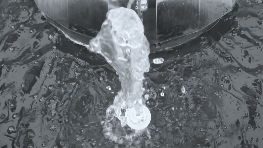 Slow motion of water fountain bursting and splashing upward