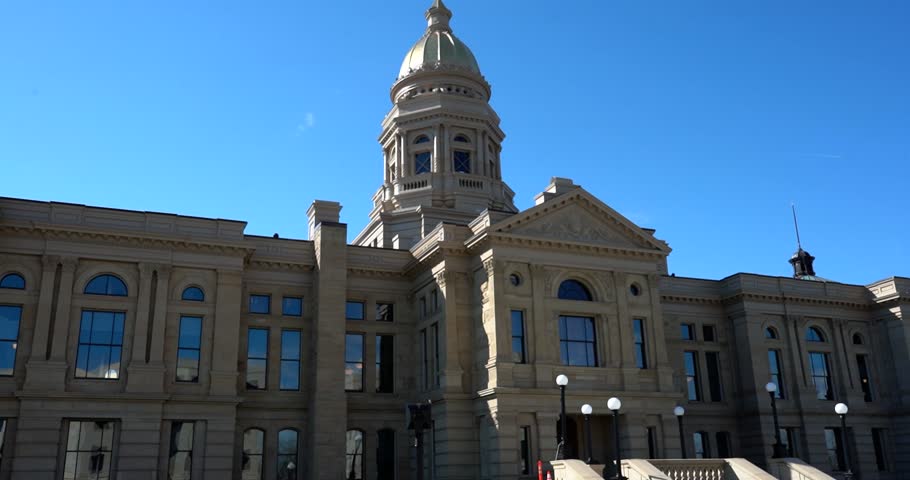 Wyoming State Capitol building front view under blue sky