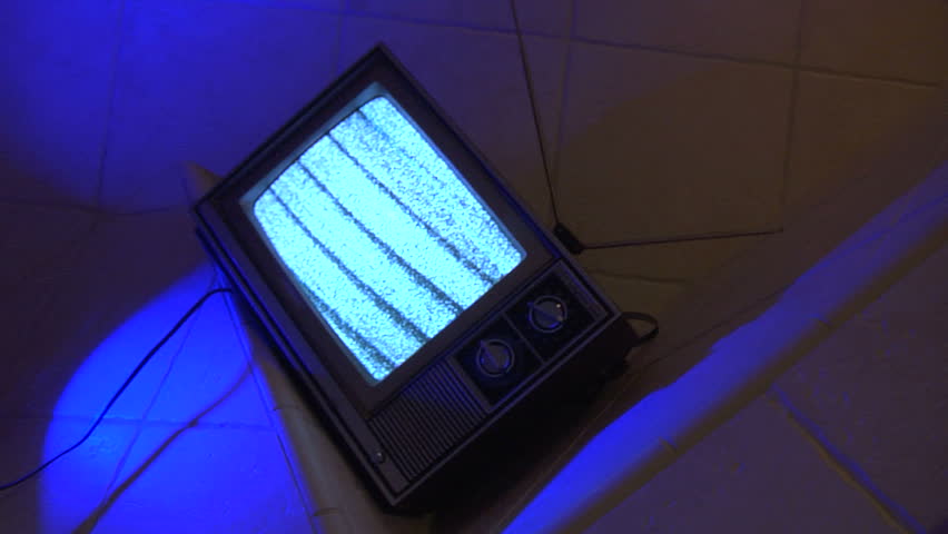 Retro TV with white noise in unique blue tile background