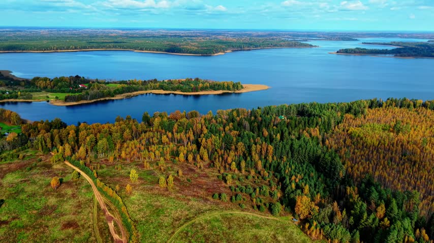 Aerial view showcasing colorful autumn foliage along a serene river landscape