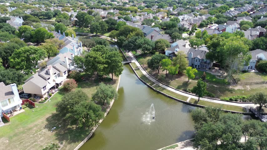 Meandering streams flow through Marshlands areas, showcasing native plant growth along Valley Ranch Corridor. Earthy banks support lush vegetation, enriching local ecology. . USA, Irving, Texas. USA.