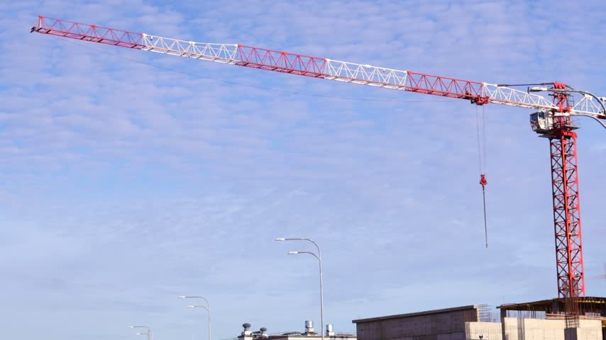 Tower Crane at Construction Site Against a Cloudy Sky