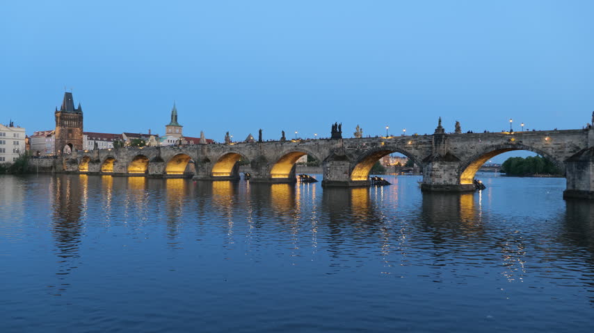 The Charles Bridge on Vltava River at dusk in city of Prague, Czech Republic.