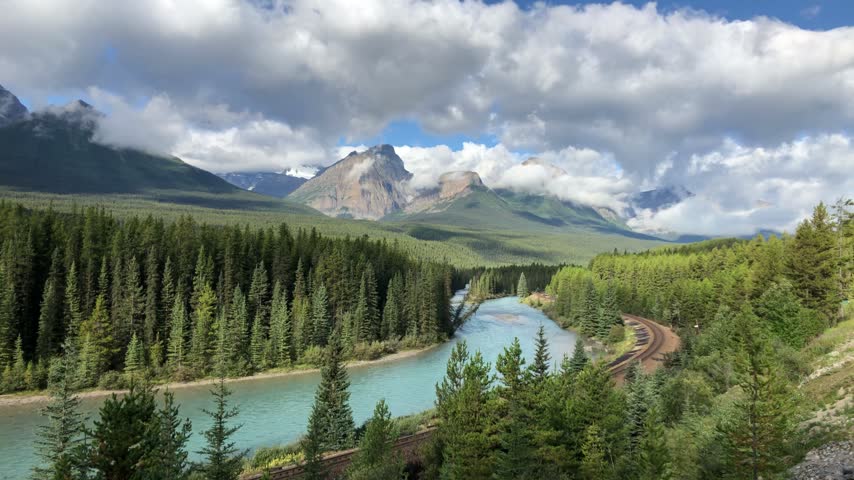 Bow River curving through evergreen forest at Morants Curve in Banff, Canada.