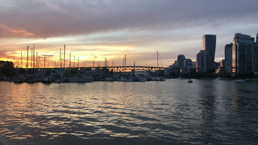 Vancouver waterfront skyline and calm False Creek at sunset, Canada.