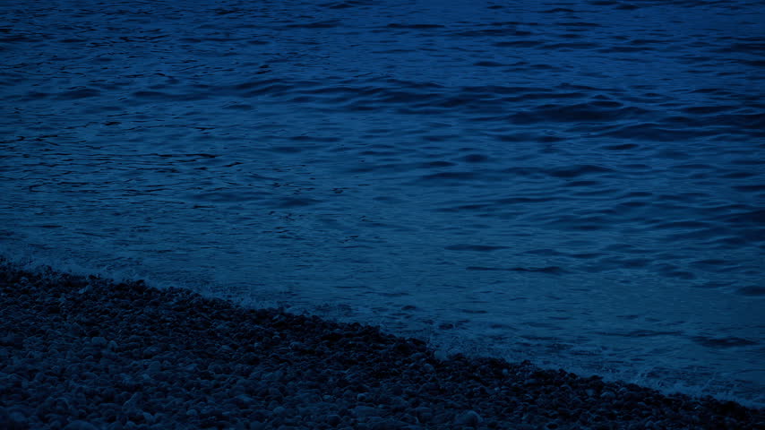 Sea Waves Lap The Shore At Dusk