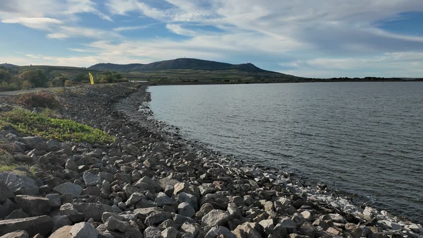 A slow panoramic sweep follows the rocky water