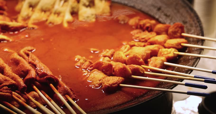 Eomuk odeng, assortment of Korean fish cake skewers on display at a street food stall in Jung-gu, Busan, Yeongnam, South Korea, white, green and fried varieties on bamboo sticks at a night market