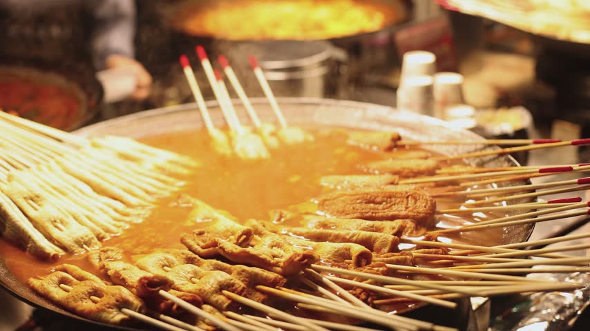 Eomuk odeng, assortment of Korean fish cake skewers on display at a street food stall in Jung-gu, Busan, Yeongnam, South Korea, white, green and fried varieties on bamboo sticks at a night market
