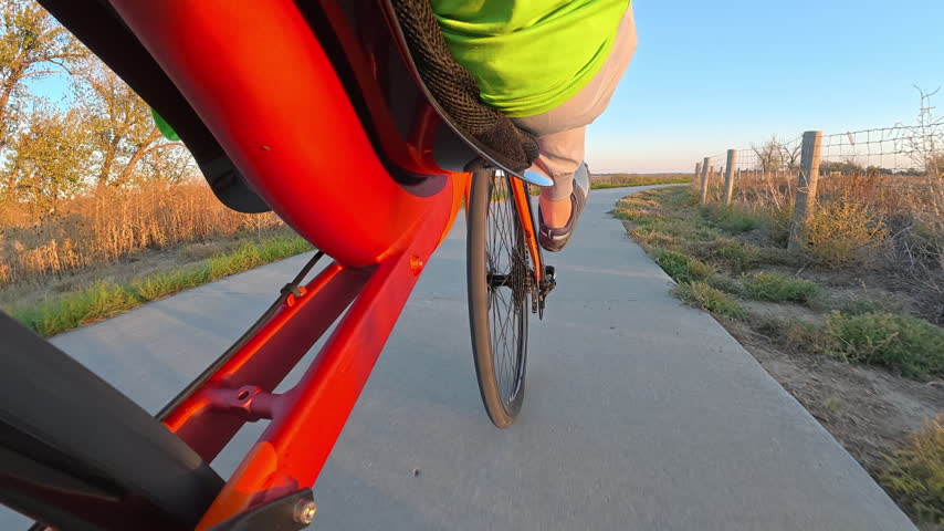 Riding a recumbent bicycle on a paved bike trail, low angle view of the front wheel - Boyd Lake State Park, Colorado
