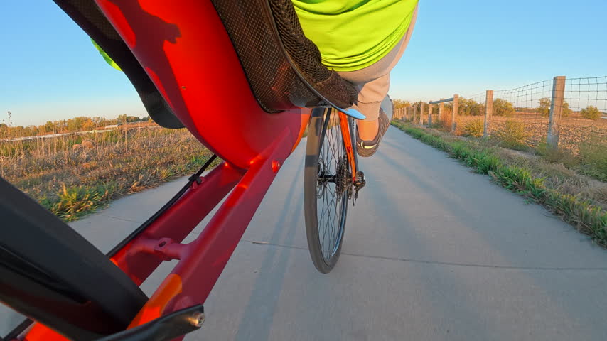 Riding a recumbent bicycle on a paved bike trail, low angle view of the front wheel - Boyd Lake State Park, Colorado