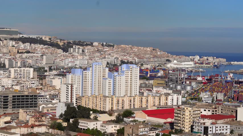 A general view of Algiers and the port of Algiers. The beauty of the Mediterranean cities and ports. Movement of ships, cargo, and containers at a Mediterranean port. Alger the capital city of Algeria