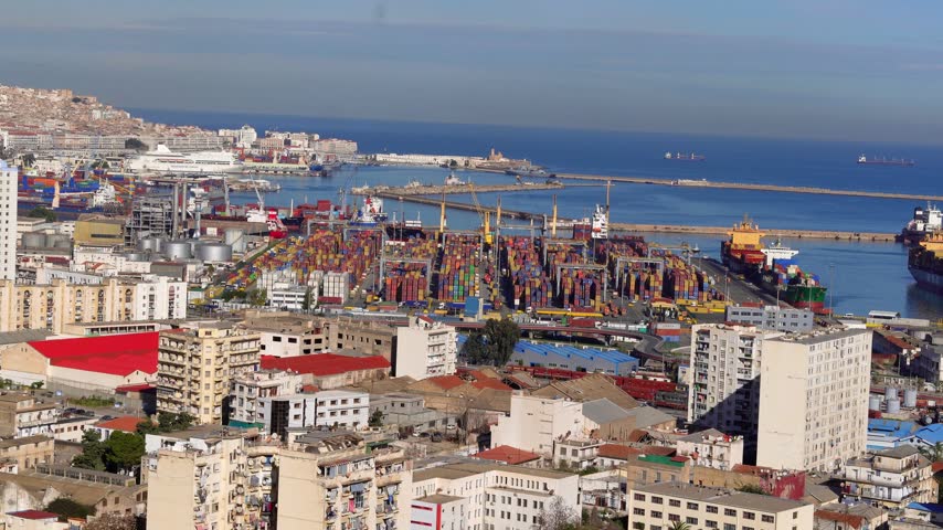 A general view of Algiers and the port of Algiers. The beauty of the Mediterranean cities and ports. Movement of ships, cargo, and containers at a Mediterranean port. Alger the capital city of Algeria