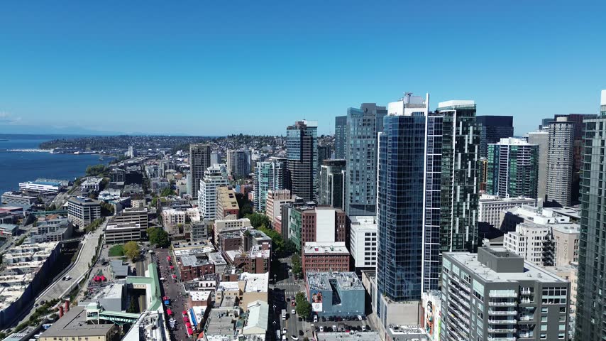 Aerial panorama of Seattle skyline along blue bay coastline