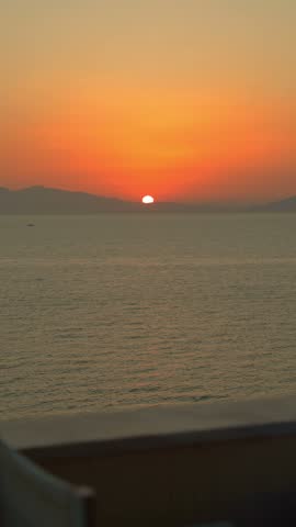 Vertical static sunset view overlooking the Aegean Sea from a terrace, Mytilene, Lesvos, Greece.